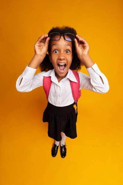 Amazed Afro Schoolgirl Screaming Looking At Camera, High-Angle