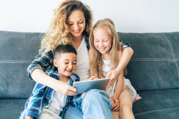istock Mother and children looking at digital tablet 1171091047