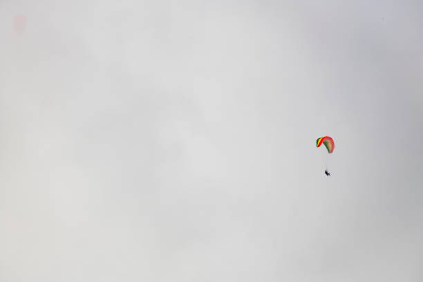 istock Two paraglider floating through clouds over Camps Bay, Cape Town. 1171091172