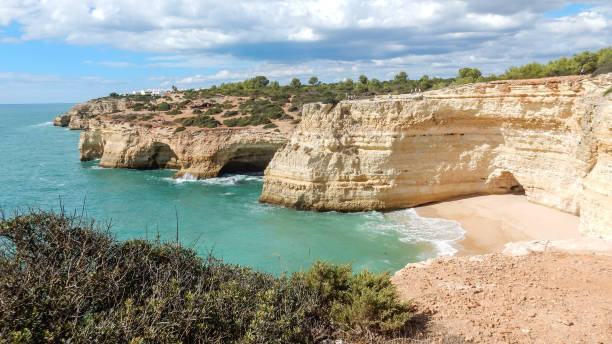 istock Panoramic view of the Algarve ocean cliffs, Portugal, with cloudy dramatic sky 1171091460
