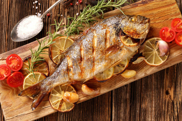 istock Roast Dorada on a wooden background 1171092433