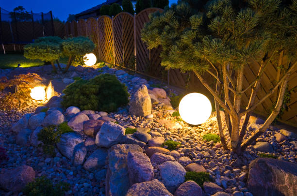 Home garden at night, illuminated by globe shaped lights Home garden at night, illuminated by globe shaped lights. Decorative gardening and landscaping abstract. ornamental garden stock pictures, royalty-free photos & images
