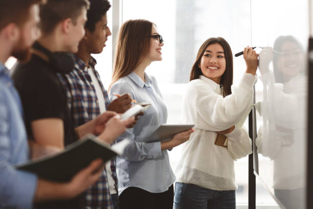 istock Girl showing answers on whiteboard in classroom 1171092550