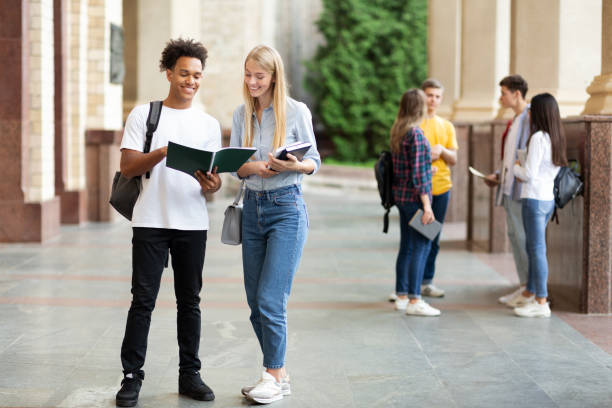 istock Teens preparing for classes with books in university campus 1171092646