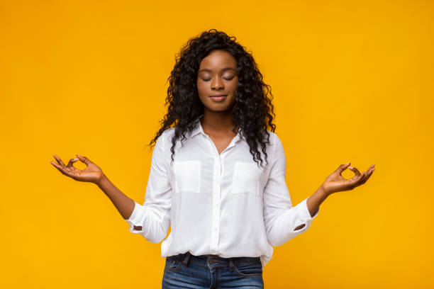 istock Young beautiful black girl practicing breathing yoga 1171092679