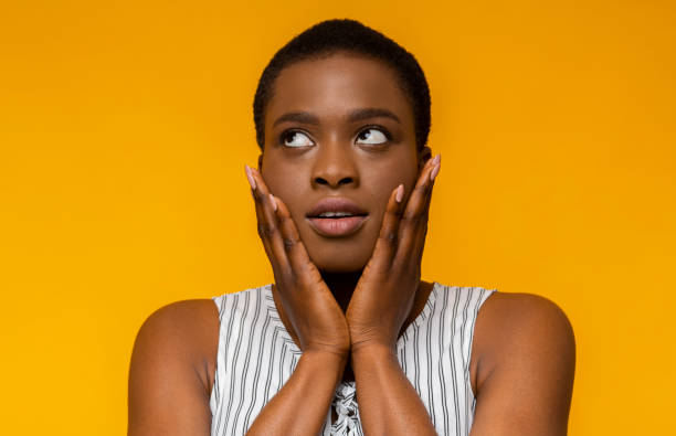istock Confused black woman touching her cheeks and looking up 1171093070