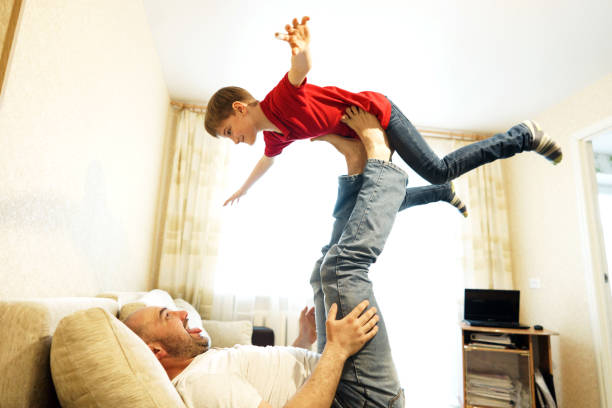 istock Father and son playing on the couch in the airplane. 1171093255
