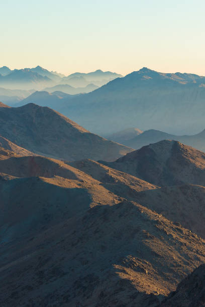 istock Beautiful view from the mountain. Panorama. Mountain range with visible silhouettes through the morning blue fog 1171094710