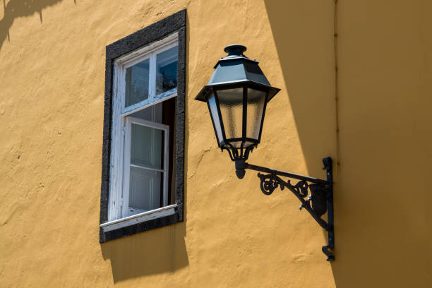 istock Stretlamp on a yellow building 1171094811