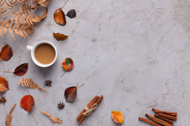 istock Cup of Coffee with colored fallen leaves on gray background 1171095104