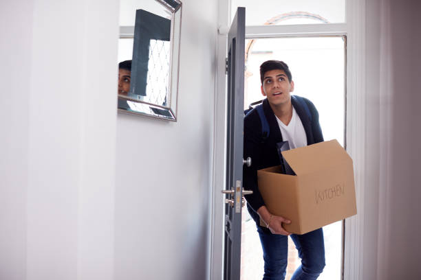 istock Male College Student Carrying Box Moving Into Accommodation 1171096743