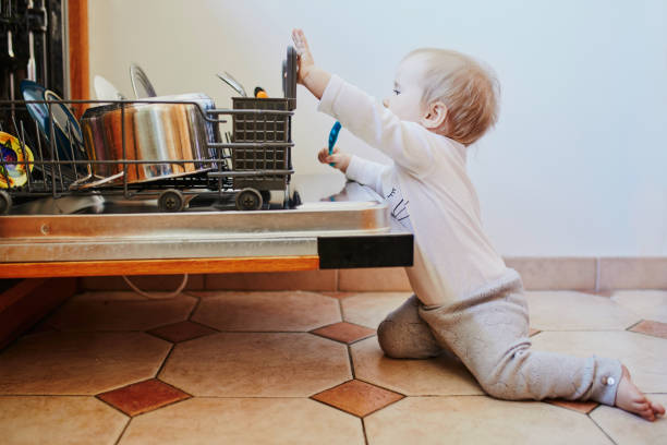 istock Little child helping to unload dishwasher 1171100475