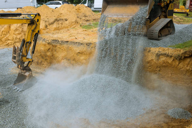 istock A bulldozer on wheels buried a excavator bucket working on the building under construction. 1171100608