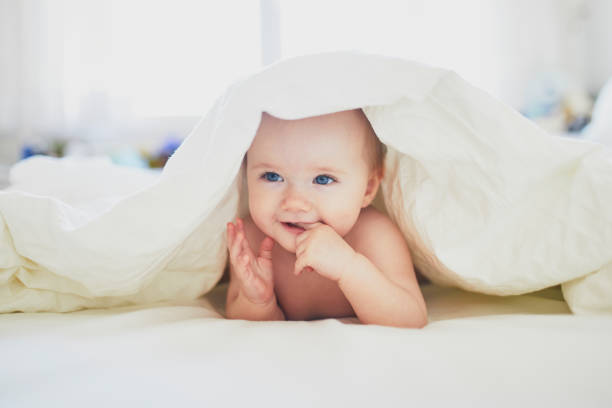 istock Cute little girl playing on bed 1171100776
