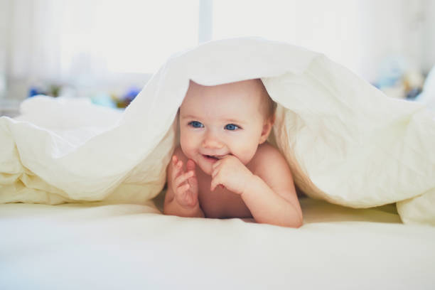 istock Cute little girl playing on bed 1171100797