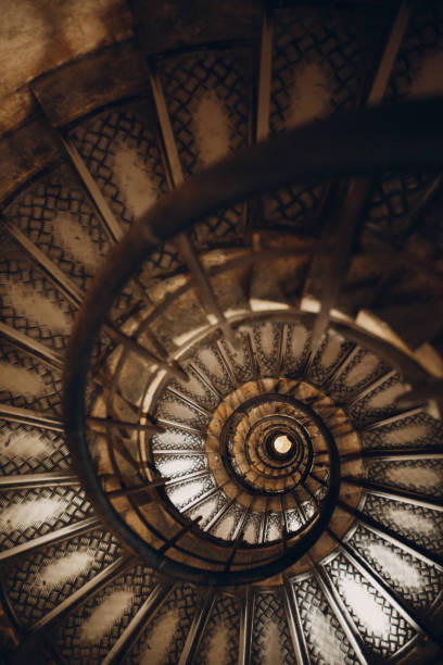 istock Spiral staircase and human hand 1171100890