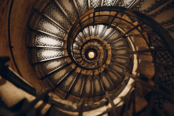 istock Spiral staircase and human hand 1171100897