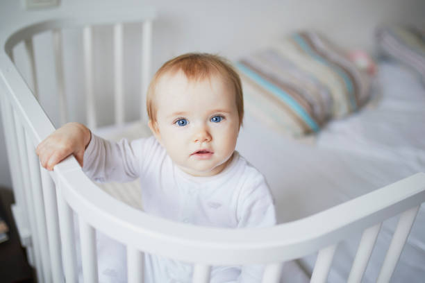 istock Adorable baby girl in co-sleeper crib 1171101870