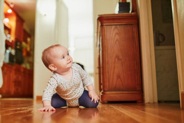 istock Baby girl learning to crawl 1171102125