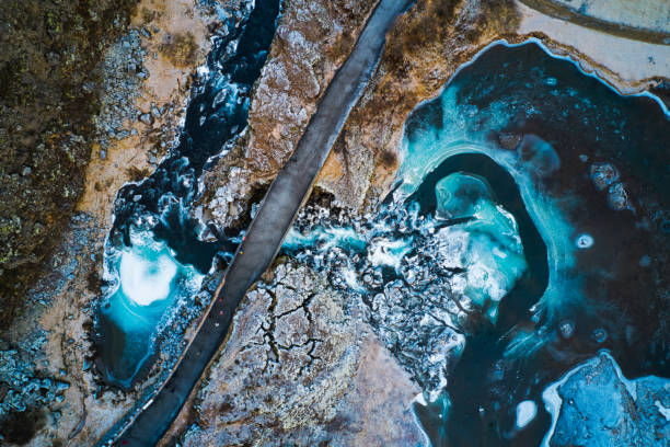 Iceland River Flow A freezing river passing under a bridge in the Pingvellir National Park, Iceland aerial view of thingvellir national park in iceland stock pictures, royalty-free photos & images