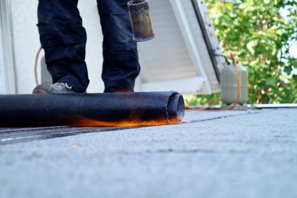 istock Flat roof installation with propane blowtorch during construction works with roofing felt. Heating and melting bitumen roofing felt. 1171113381