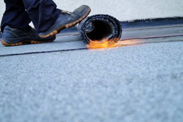 istock Flat roof installation with propane blowtorch during construction works with roofing felt. Heating and melting bitumen roofing felt. 1171113389
