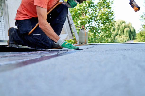 Flat roof installation with propane blowtorch during construction works with roofing felt. Heating and melting bitumen roofing felt. stock photo