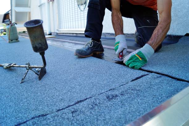 istock Flat roof installation with propane blowtorch during construction works with roofing felt. Heating and melting bitumen roofing felt. 1171114089