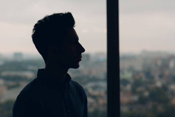 istock Young male profile portrait against window 1171115425