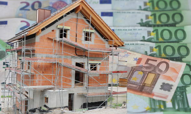 House under construction with Euro banknotes in background stock photo