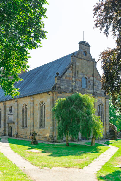 istock Church in Bad Bentheim, Germany, with grass field and walking path 1171118301