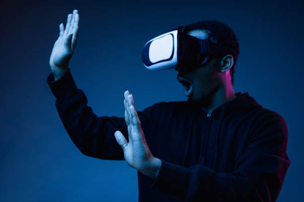 istock Young african-american man's using VR-glasses in neon light 1171119558