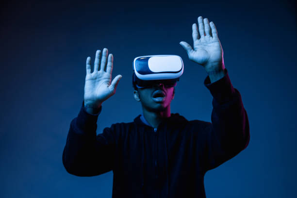 istock Young african-american man's using VR-glasses in neon light 1171119562