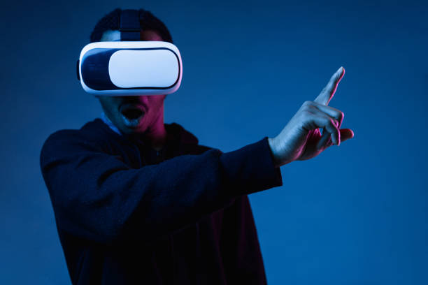 istock Young african-american man's using VR-glasses in neon light 1171119570