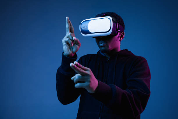 istock Young african-american man's using VR-glasses in neon light 1171119595