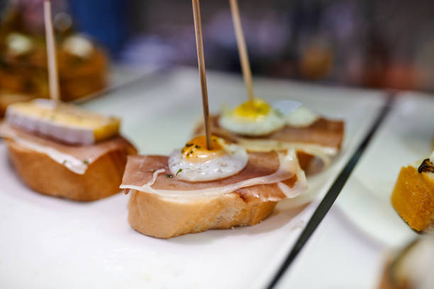 Closeup of a plate of finger food placed on top of a table ready to be eaten inside of a restaurant
