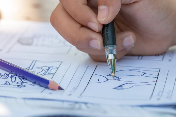 istock Hands drawing storyboard animation comic for pre-production process, design creative story scene layout in movie carton at studio. Behind making work before production film or video presentation 1171123100