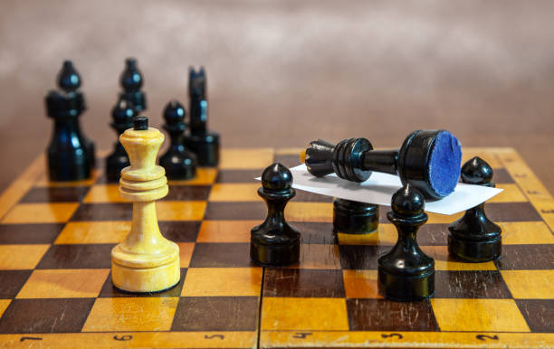 istock black pawns carry the killed king on a stretcher 1171124293