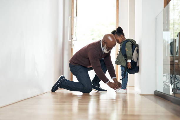 He's as proud as a grandpa can be Shot of a senior man leaving home to take his granddaughter to school child tied up stock pictures, royalty-free photos & images