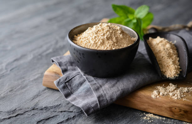 istock Dietary supplement, Maca root powder in a bowl and scoop with copy space 1171125934