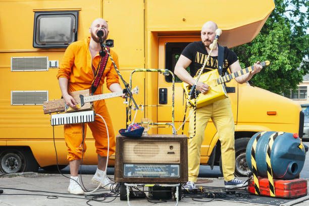 Eccentric two man rock band with handmade musical instruments on the street Vilnius, Lithuania - May 18, 2019: Eccentric two man rock band with handmade musical instruments performing on the street at traditional street music day in Vilnius, Lithuania rock musician photos stock pictures, royalty-free photos & images