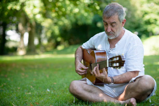 istock Senior flamenco guitar player practicing his art in a public park 1171128431