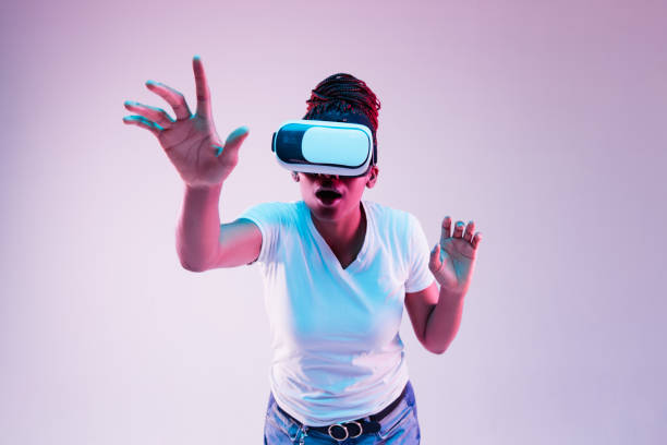 istock Young african-american woman's using VR-glasses in neon light 1171128458