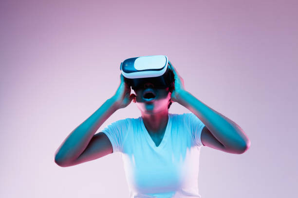 istock Young african-american woman's using VR-glasses in neon light 1171128519
