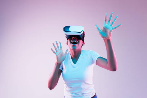 istock Young african-american woman's using VR-glasses in neon light 1171128523