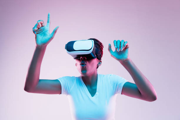 istock Young african-american woman's using VR-glasses in neon light 1171128674