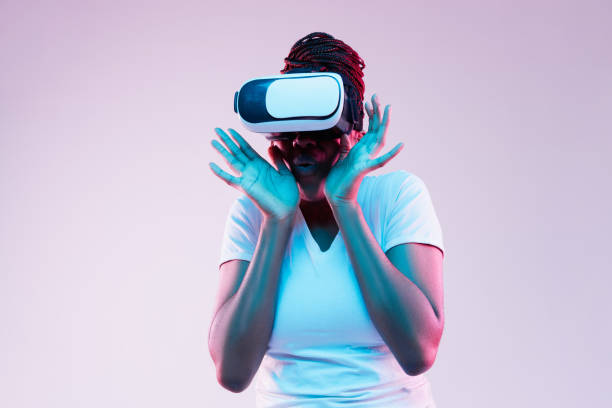 istock Young african-american woman's using VR-glasses in neon light 1171128700