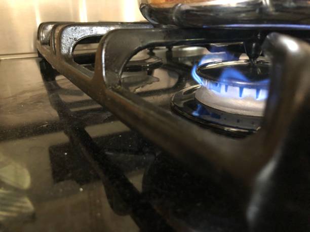 istock Blue gas flame on stove top under a pan 1171128818
