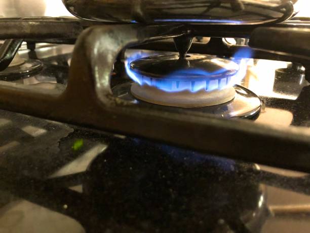 istock Blue gas flame on stove top under a pan 1171128837