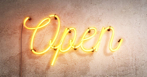 Bright neon red/yellow sign saying the word Open,